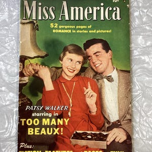 May include: A vintage "Miss America" magazine cover. The cover is green with the title in white and the text "52 gorgeous pages of ROMANCE in stories and pictures!". The magazine features Patsy Walker starring in "TOO MANY BEAUX!"