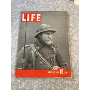 May include: Vintage LIFE magazine cover from March 11, 1940, featuring a soldier in uniform. The magazine title "LIFE" is in a white font on a red background. The cover also includes the price "10 CENTS".