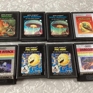 Lot of 8 Atari Video Game Cartridges Pac Man Space Invaders Dragonfire Demon Attack