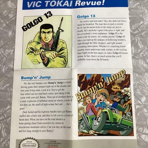 May include: A colorful illustration of a video game cover for the Nintendo Entertainment System. The cover features a cartoon image of a green car driving through a desert landscape. The text on the cover reads "Bump'n' Jump".