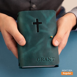 May include: A teal leather-bound journal with a cross and the name "GRANT" embossed on the front cover.
