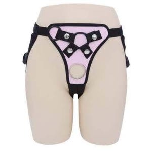 May include: Pink and black adjustable harness with metal rings and straps.