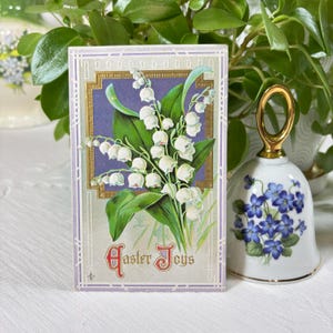 Carte postale ancienne des Joies de Pâques - Muguet dans un cadre en relief doré - Pas de cachet de la poste, de timbre ou d'écriture au dos