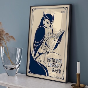 May include: A framed rectangular poster featuring a dark blue illustration of an owl reading a book on a cream background. The text reads 1958 and NATIONAL LIBRARY WEEK. The poster is enclosed in a thin black frame with decorative border lines.
