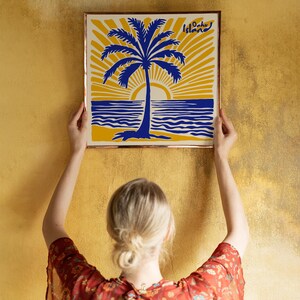 May include: A framed print with a yellow background, blue palm tree, and blue ocean waves. The text 'Oahu Island' is in the top right corner of the print.