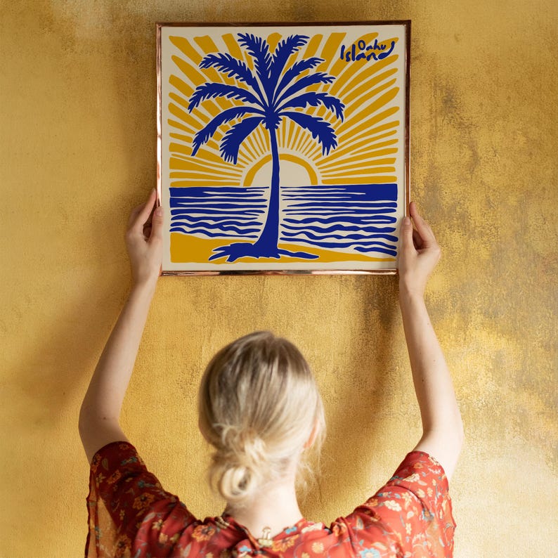 May include: A framed print with a yellow background, blue palm tree, and blue ocean waves. The text 'Oahu Island' is in the top right corner of the print.