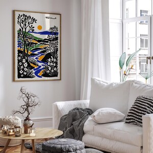 May include: A framed print of a stylized landscape with a river flowing through a valley. The print is in black, white, blue, yellow, and green. The text "Vermont" is in the upper right corner of the print.