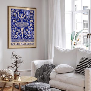 May include: A blue and white poster with a ballerina dancing in a field of flowers. The poster has the text "Belles Ballerines" at the bottom.