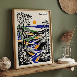 May include: A framed print of a stylized landscape with a river, trees, and flowers in black, blue, green, yellow, and white. The print is titled "Vermont".