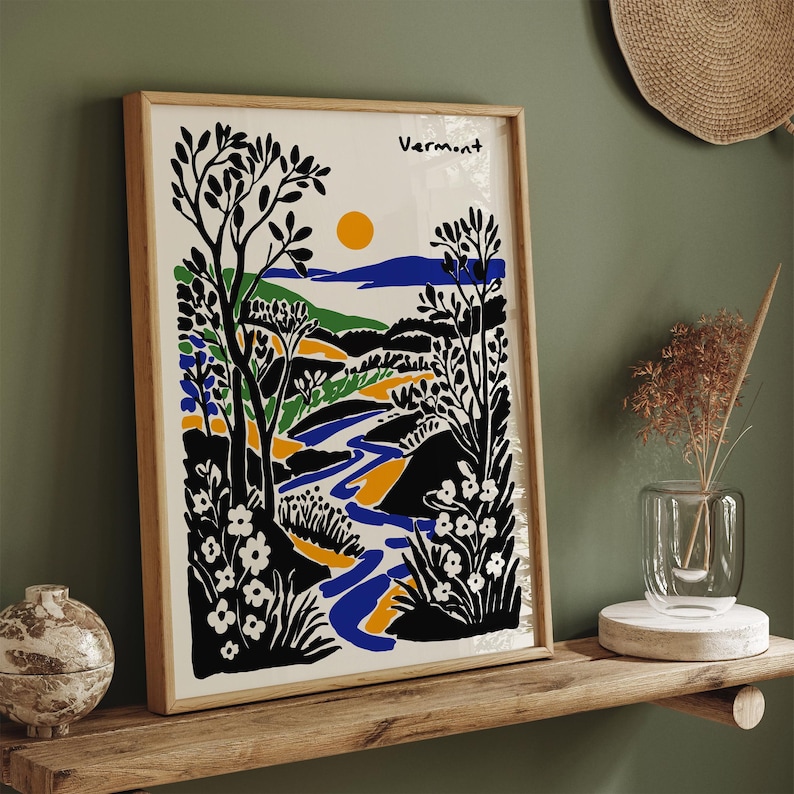 May include: A framed print of a stylized landscape with a river, trees, and flowers in black, blue, green, yellow, and white. The print is titled "Vermont".