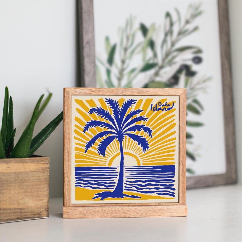 May include: A wooden framed square sign with a yellow background and a blue palm tree silhouette. The sun is setting behind the palm tree and the words 'Oahu Island' are in the top right corner.