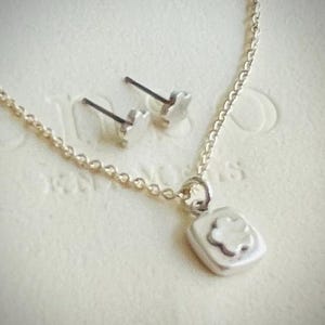 Silver flower pendant and earring set.