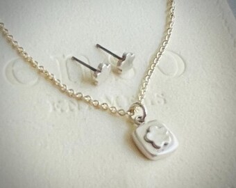 Silver flower pendant and earring set.