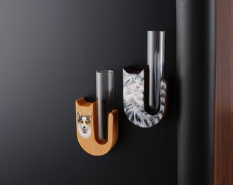 May include: Two wooden wall mounted flower vases with a cat and a dog design. The vases are painted with a realistic image of a cat and a dog. The vases are made of wood and have a natural finish.