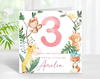 May include: A pink and white birthday card with a pink number 3, a monkey, a giraffe, a bear, and a fox. The card says "Happy 3rd Birthday to a special little girl Amelia".