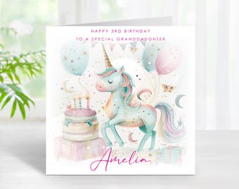 May include: A birthday card featuring a watercolor illustration of a unicorn with a golden horn, surrounded by balloons and a cake. The card reads "Happy 3rd Birthday to a Special Granddaughter" with the name "Amelia" in cursive.