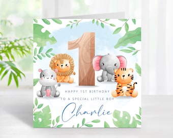 May include: A birthday card with a jungle theme. The card features a large wooden number one, a lion, an elephant, a tiger, and a hippopotamus. The card says "Happy 1st Birthday to a special little boy Charlie".
