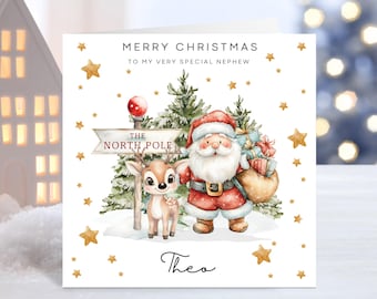 Peut inclure: Carte de Noël avec une illustration de Père Noël, d'un renne et d'un panneau "Le Pôle Nord". La carte porte l'inscription "Joyeux Noël à mon très cher neveu" et des étoiles dorées. Le nom "Théo" est écrit en bas.