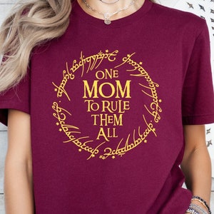May include: Burgundy t-shirt with a gold graphic of the One Ring from Lord of the Rings. The graphic says "One Mom To Rule Them All".
