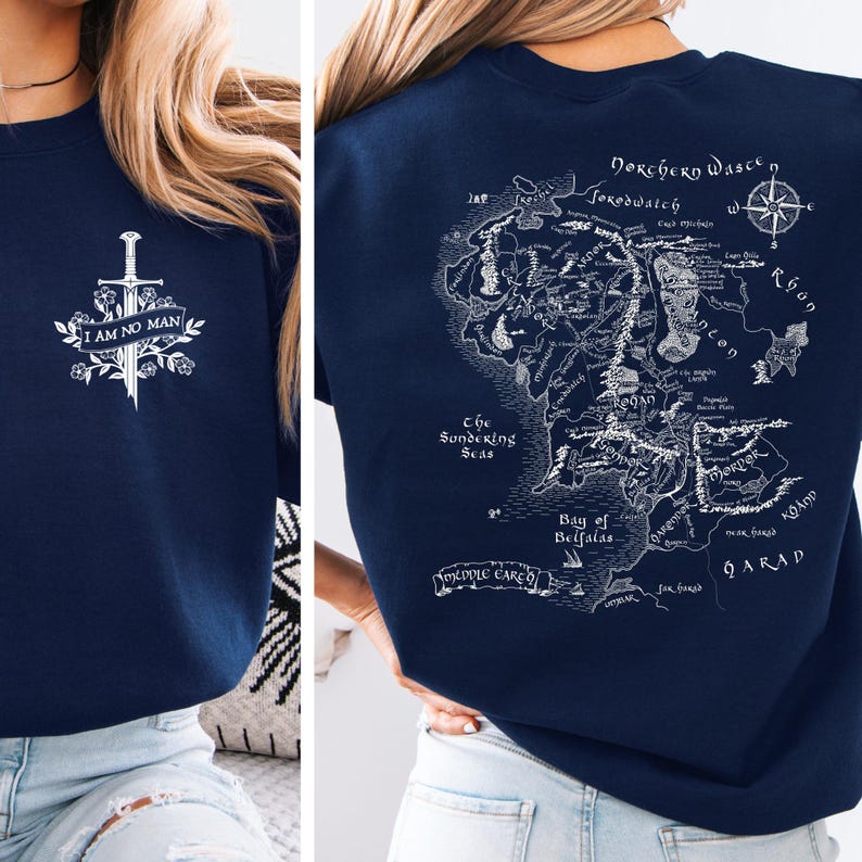 May include: Navy blue sweatshirt featuring a white graphic of a sword and the text "I AM NO MAN" on the front. The back displays a detailed map with text, including "Middle Earth" and "Bay of Belfalas".