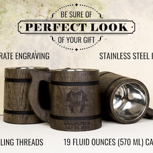 May include: Wooden beer tankards with stainless steel interiors. The tankards have a dark wood finish with encircling threads and handles. One tankard is engraved with a name, the word "Groomman", and a date. The text "BE SURE OF PERFECT LOOK OF YOUR GIFT" is at the top.