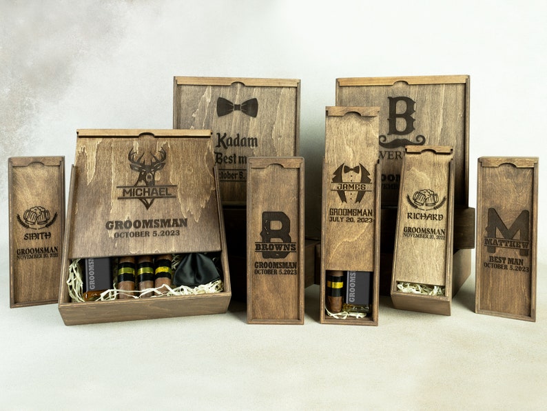 May include: Wooden gift boxes with engraved designs and names. The boxes are for groomsmen and the best man. Some boxes include cigars and a bow tie.