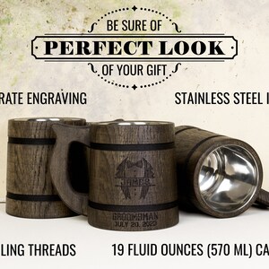May include: Two wooden beer steins with stainless steel interiors. The steins are engraved with the text "Groomesman" and "July 20, 2023". The steins have a capacity of 19 fluid ounces (570 ml).