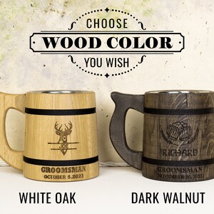 May include: Two wooden beer mugs with personalized engravings. The mug on the left is made of white oak and features a deer design with the name "Joe" and the text "Groomsman October 5, 2023". The mug on the right is made of dark walnut and features a beer stein design with the name "Richard" and the text "Groomsman November 20, 2023".
