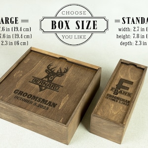 May include: Two wooden boxes with engraved text. The larger box is 7.6 inches wide, 7.6 inches high, and 2.3 inches deep. The smaller box is 2.7 inches wide, 7.8 inches high, and 2.3 inches deep. Both boxes have a brown wood finish and feature a deer head design with a name and the word "Groomsmans" engraved on the top.