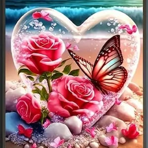 May include: A heart-shaped glass orb with a pink rose and a butterfly inside, surrounded by white stones and a sandy beach background.
