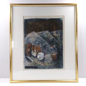 May include: A framed print of a still life painting featuring a glass of liquid, bread, and a piece of cheese on a newspaper. The painting is done in a dark blue, brown, and white color palette.