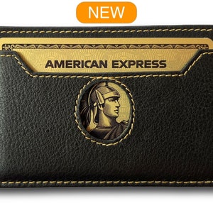 May include: Black leather card holder with a gold stitched border and a cutout for a gold American Express card. The card holder has a gold embossed logo of a Roman soldier's head.