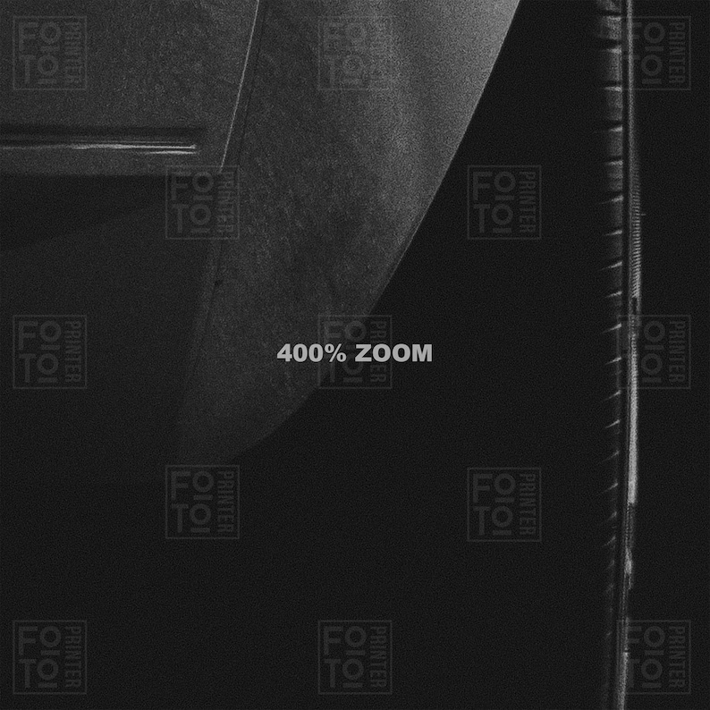 May include: A grayscale image with the text "400% ZOOM" in the center. The image has a textured appearance with a curved edge on the left and a vertical ruler-like element on the right.