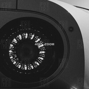 May include: Close-up, black and white image of a circular object with a bright, illuminated ring of lights. The text "400% ZOOM" is visible. The object appears to be part of a larger machine or device.