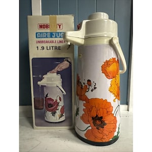 May include: Vintage Nobility Aire Jug, featuring a white and orange floral design. The thermos has a white handle and spout, and the box reads "Unbreakable Liner" and "1.9 Litre".