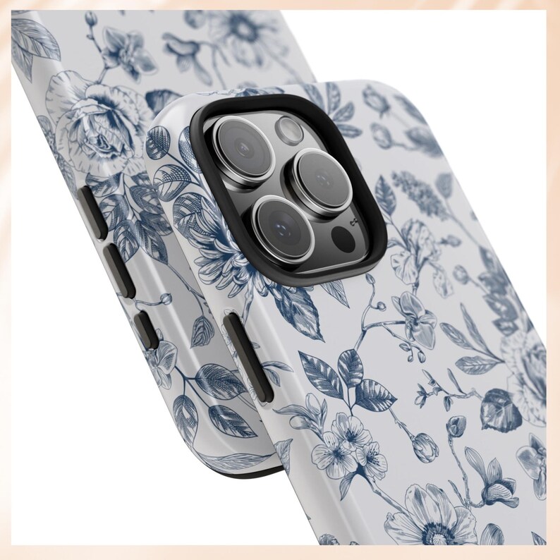 May include: A white phone case with a blue floral pattern. The case has a raised camera bump with three black camera lenses.