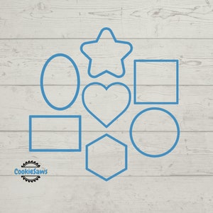 May include: A set of seven blue cookie cutters in different shapes: a star, a heart, a circle, a hexagon, an oval, and two rectangles. The cutters are on a light wood background.