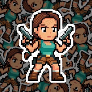 May include: A pixelated sticker of a video game character holding two guns. The character wears a teal top, brown shorts, and boots. The sticker has a white border. The text "StickerFrenzy's" is visible on the sticker.