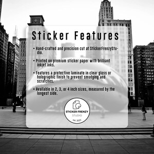 a sticker with a cityscape background, including tall buildings and a glass window. The sticker is hand-crafted and precision cut at StickerFrenzyStu.dio, printed on premium sticker paper with brilliant inkjet inks, and features a protective laminate finish to prevent smudging and scratches. The sticker is available in 2, 3, or 4 inch sizes, measured by the longest side.