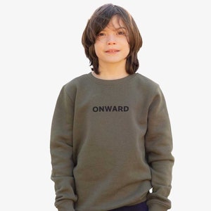 May include: A young person wearing a green sweatshirt with the word "ONWARD" printed on the front. The sweatshirt has long sleeves and a crew neck.
