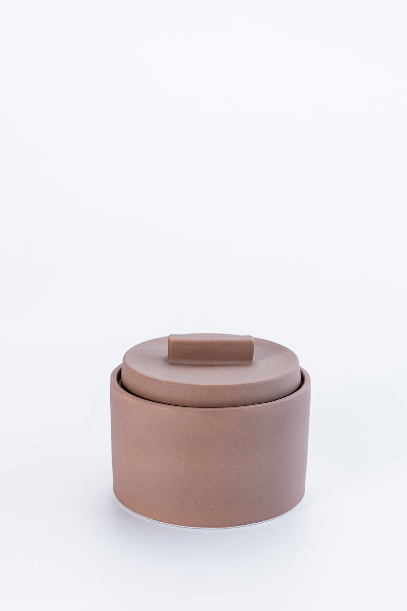 Modern handmade ceramic storage container. Exceptionally handcrafted. Available in white and cinnamon. Cinnamon