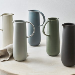 Modern handmade ceramic carafe. Exceptionally handcrafted. Available in white, blue grey, sage green, grey, and black.