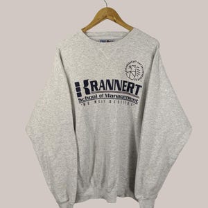 May include: Grey sweatshirt with a navy blue logo that reads "Krannert School of Management The Meit Business" and a Purdue University crest.