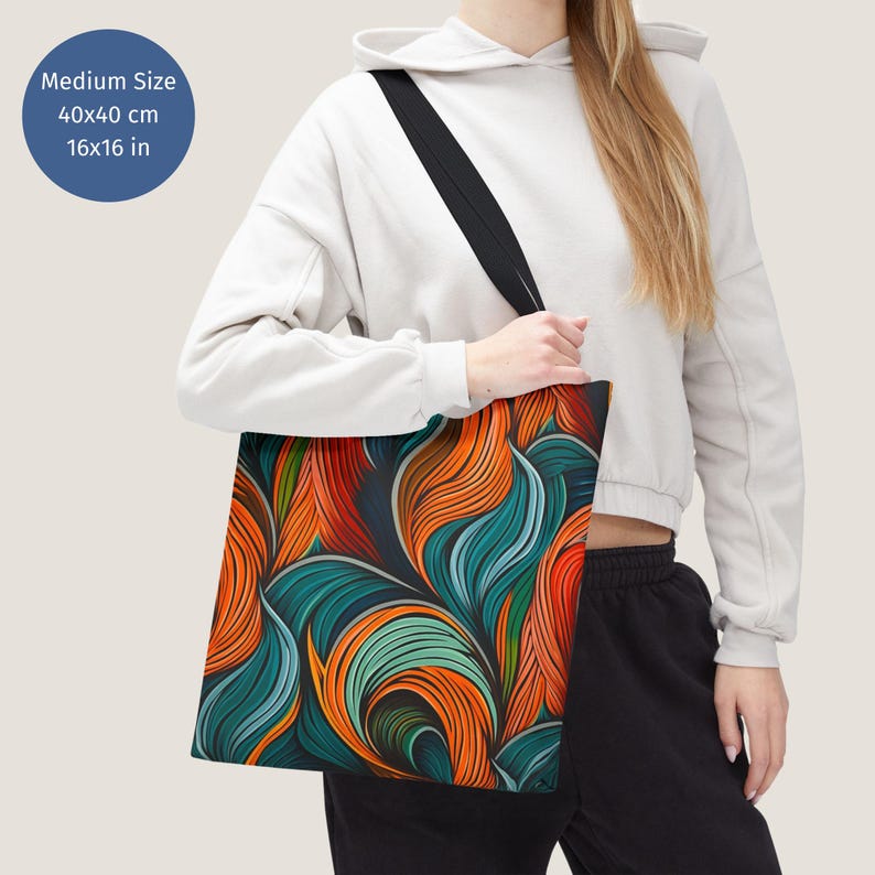 May include: A tote bag with a colourful abstract design featuring swirling lines in shades of orange, blue, and green. The bag is made of canvas and has a black strap. The bag measures 40x40 cm.