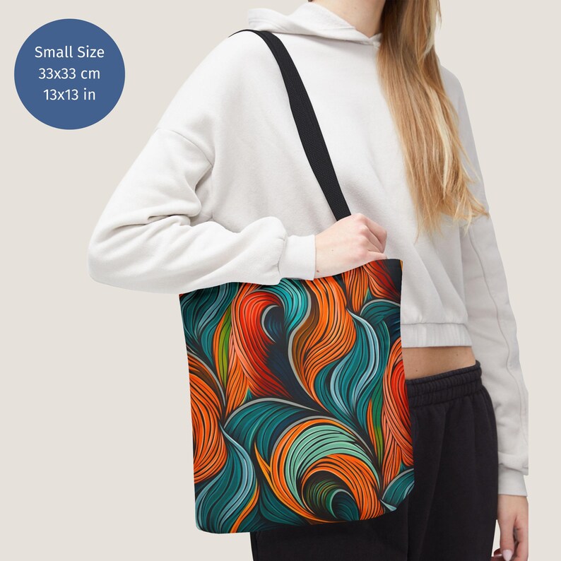 May include: A tote bag with a colourful abstract design featuring swirling lines in shades of orange, blue, and green. The bag is 13x13 inches.