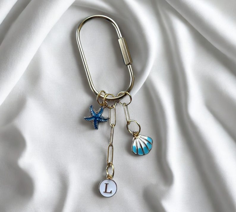 Preppy coastal bag charm featuring blue enamel seashell, starfish, and phrase ‘Last Toast On the Coast’—great as bridal party favor or destination wedding keepsake