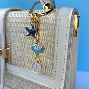 Nautical-inspired purse accessory: blue shell and starfish charm with ‘Last Toast On the Coast’ text, perfect for keychains, tote decorations, or bridesmaid gifts