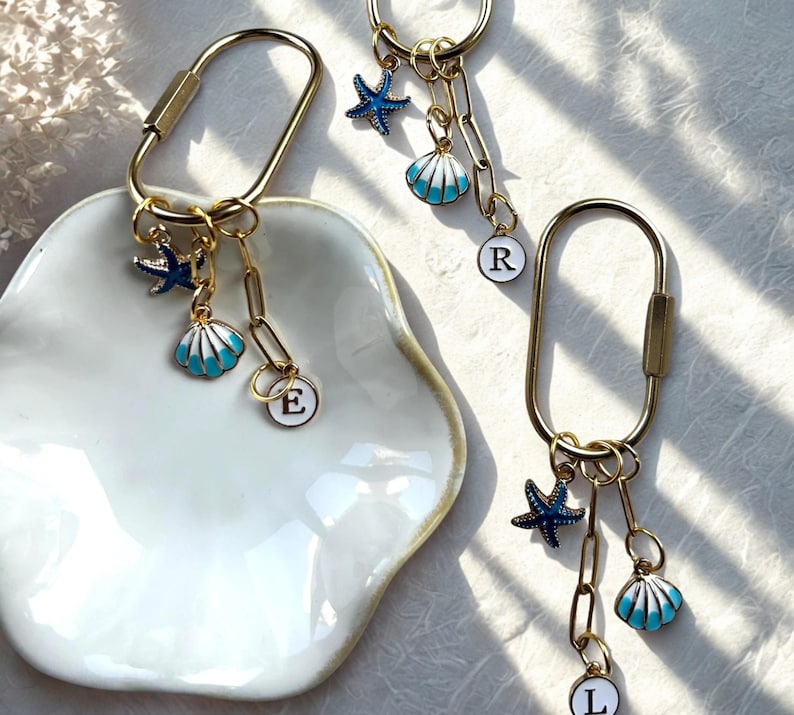 Blue coastal tote bag charm with enamel seashell and starfish, engraved ‘Last Toast On the Coast’, ideal for bachelorette favors or beach-themed accessories