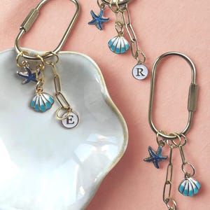 Ocean-themed keychain clip featuring ‘Last Toast On the Coast’ charm, blue seashell and starfish, perfect coastal reminder or travel accessory for bachelorette trips