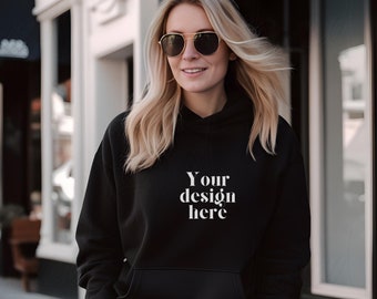 May include: A black hoodie with a white text overlay that says "Your design here".